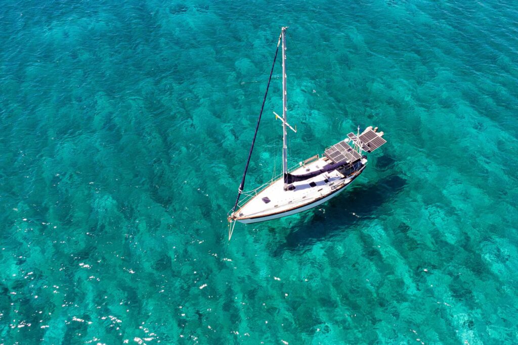 Sail boat sitting on clear blue water | Featured image for the Marine Hot Water Systems Page of BCA Australia.